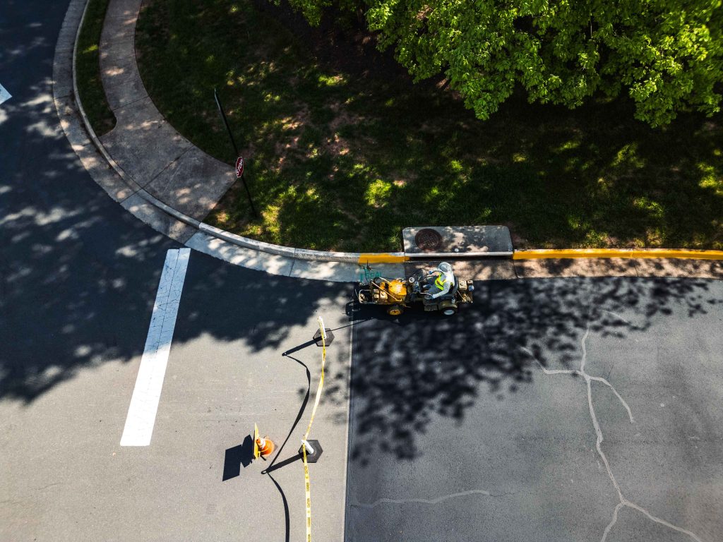 employee using a machine on the road