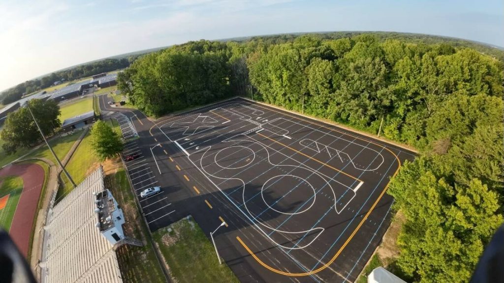 aerial view of an empty parking lot surrounded by trees