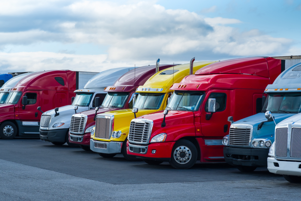 Colorful large trailer trucks parked in a lot